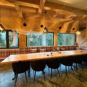 Traditional highland-style dining room, decorated with folk patterns and warm lighting.